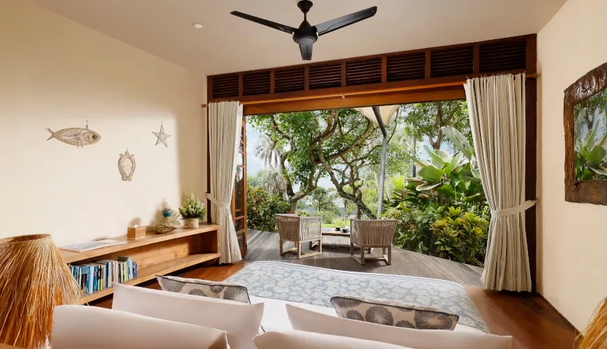 Balinese bedroom with lush jungle views and an inviting private balcony at The Cove Bali