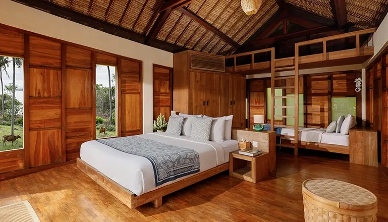 Bedroom features a main bed and unique elevated loft sleeping area at The Cove Bali