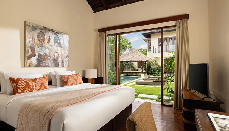 Bedroom with king bed pool view and outdoor gazebo at The Suar Seminyak