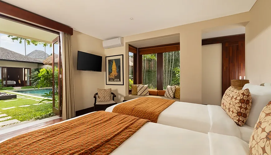 Comfortable twin room with a tropical feel and direct access to an outdoor swimming pool at The Suar Seminyak