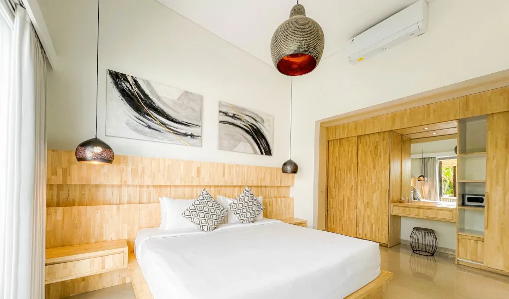 Cozy bedroom with a queen-size bed and a bright, modern aesthetic at The Suar Sanur