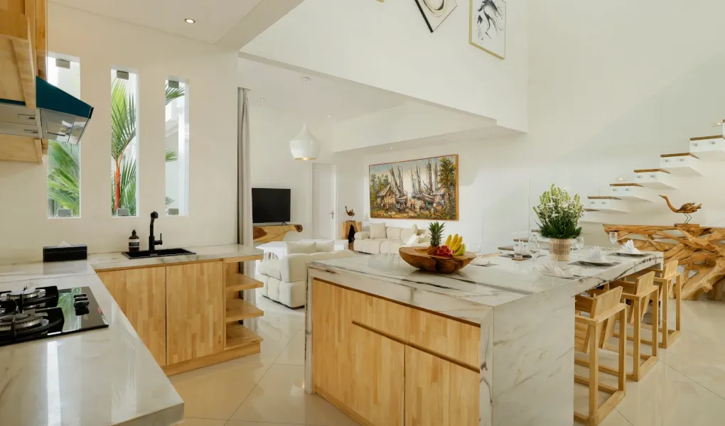 Elegant open-plan living and dining area with modern kitchen at The Suar Sanur