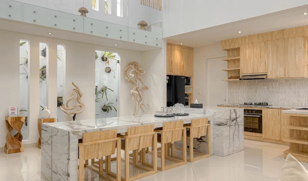 Luxury marble kitchen with wooden cabinetry and island at The Suar Sanur