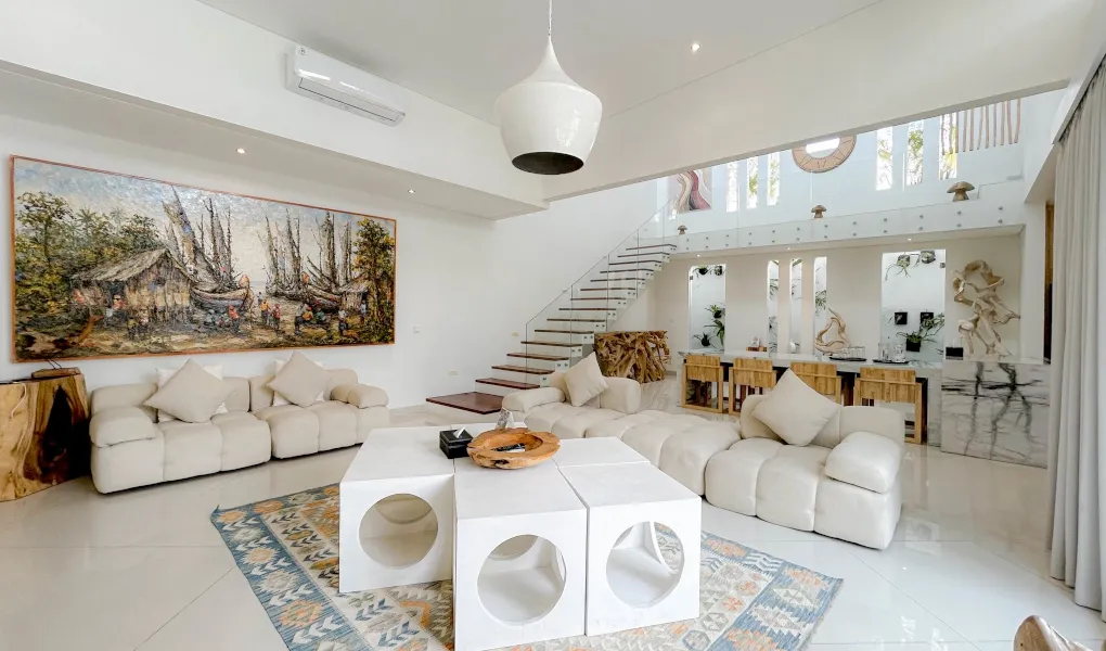 Open-concept living and dining area with a large wooden table and chairs at The Suar Sanur