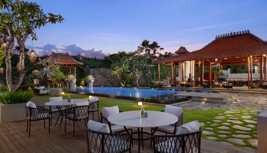 Poolside restaurant at a luxury Bali resort at sunset at The Tulou Bali Villa