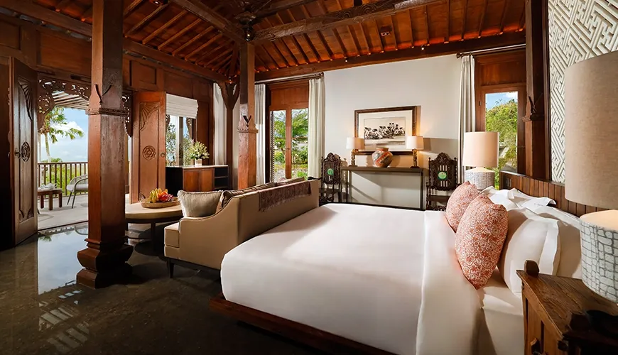 Traditional Bali bedroom with handcrafted wood at The Tulou