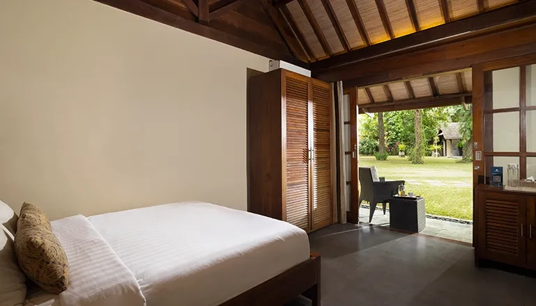 Bright sleeping space featuring simple decor and natural light at Tirtadari Villa