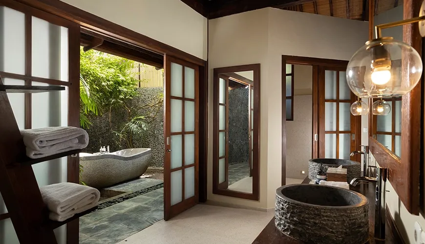 Luxurious bathroom featuring a modern design and lush greenery at Tirtadari Villa