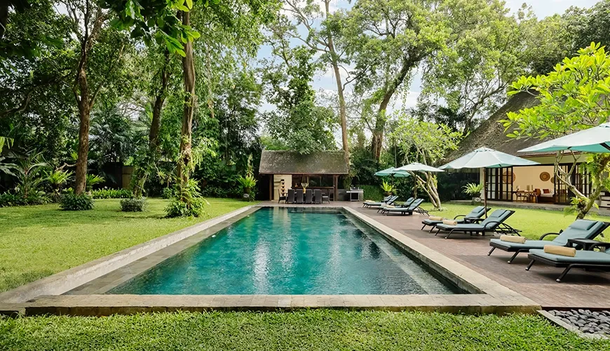 Luxurious pool area perfect for relaxation and sunbathing at Tirtadari Villa