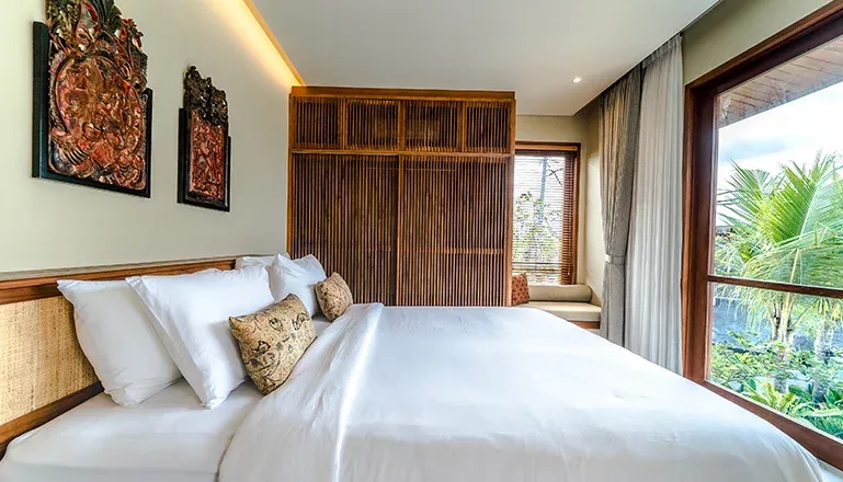 Elegant balinese villa bedroom with traditional decor at Uma Berawa Villa