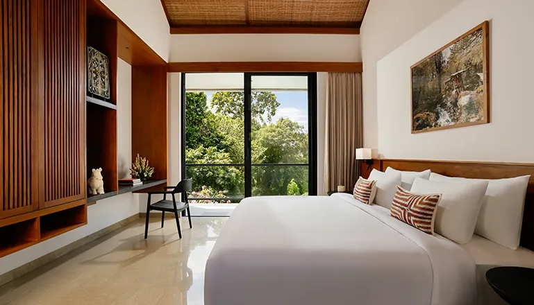 Minimalist and stylish villa bedroom with a comfortable bed and floor-to-ceiling windows for natural light at Uma Santai Canggu