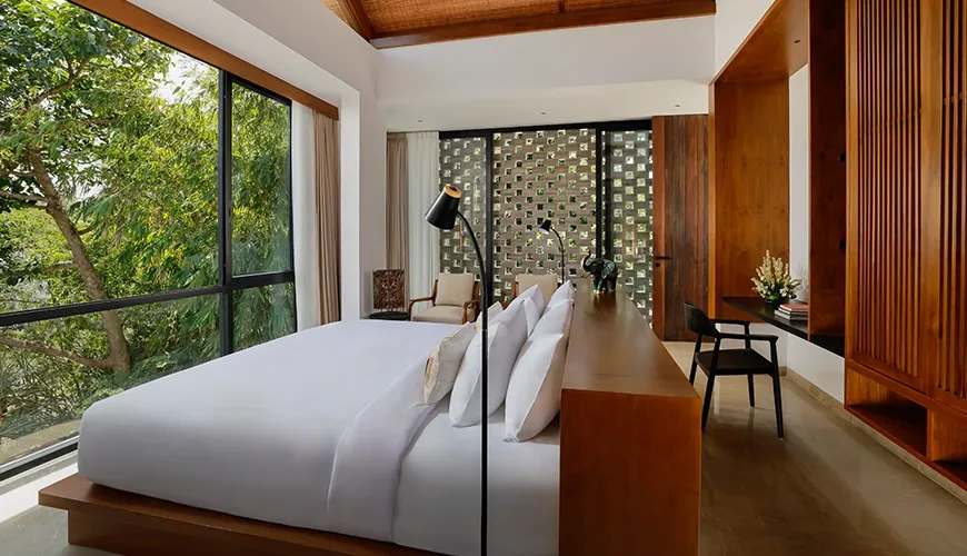 Minimalist bedroom in a villa with large windows that provide abundant natural light and a serene atmosphere at Uma Santai Canggu
