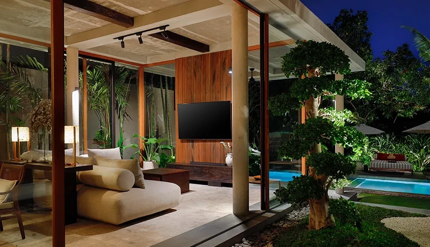 Contemporary open concept villa living room featuring a flat screen television and beautiful pool view patio at Uma Santai Pererenan