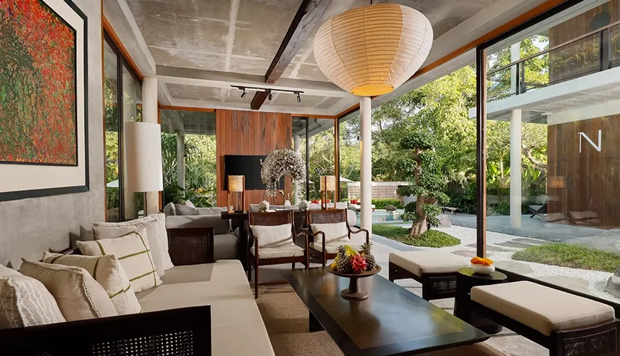 Luxurious interior design showcasing a relaxed contemporary lounge area and stunning outdoor view at Uma Santai Pererenan