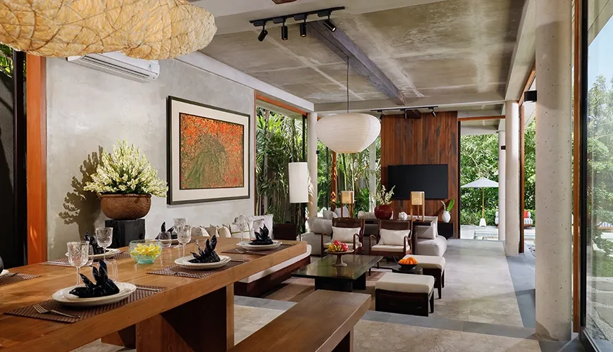 Luxurious living space design with a large modern dining setup and serene views of the outdoor landscape at Uma Santai Pererenan
