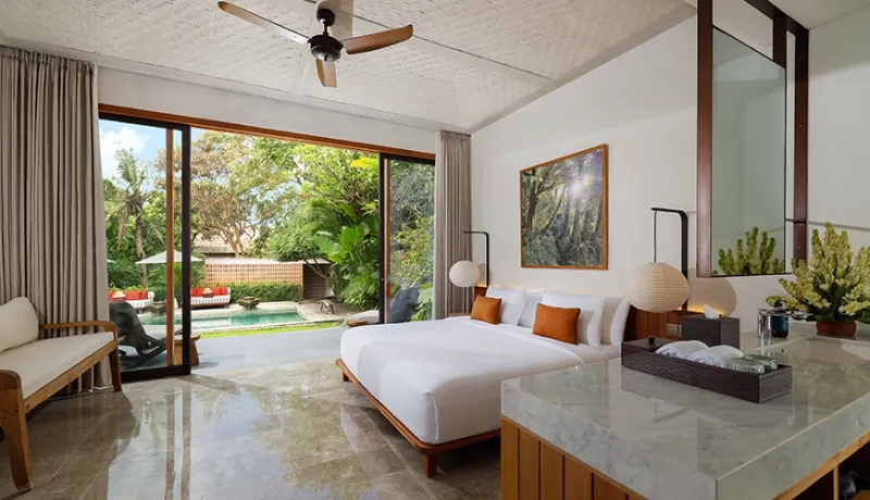 Luxurious master bedroom villa suite features a comfortable king size bed and private swimming pool view at Uma Santai Pererenan