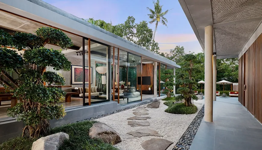 Stunning modern villa architecture featuring a tranquil outdoor gravel garden and stepping stones at Uma Santai Pererenan