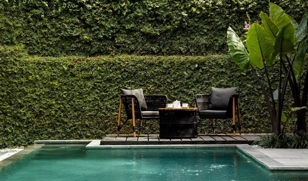 Cozy outdoor seating area next to a private swimming pool at Villa Ambara