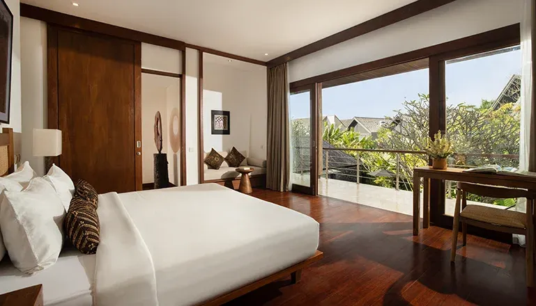Elegant Bali bedroom with balcony and outdoor view at Villa Ambara