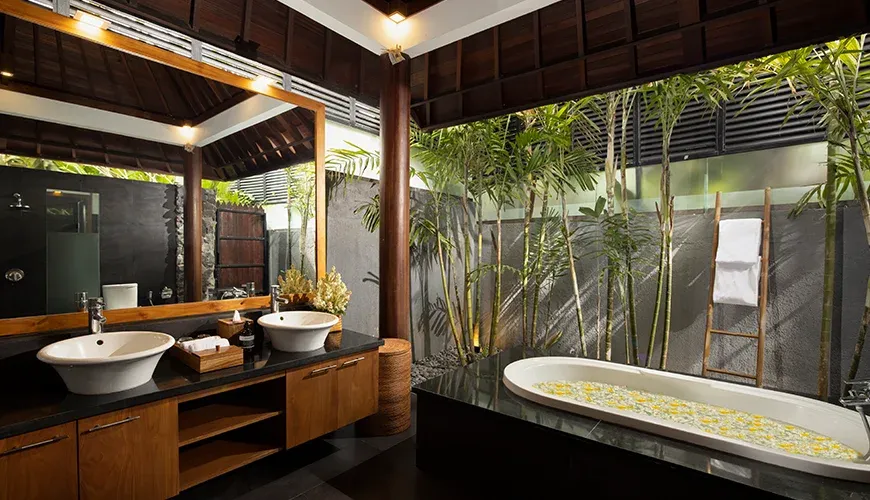 Luxurious Bali bathroom with soaking tub and garden view at Villa Ambara