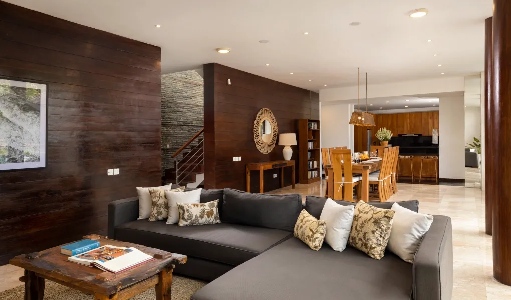 Open-concept living and dining area with modern wooden walls at Villa Ambara