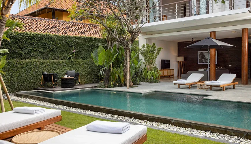 Tropical Bali getaway features poolside lounging and greenery at Villa Ambara