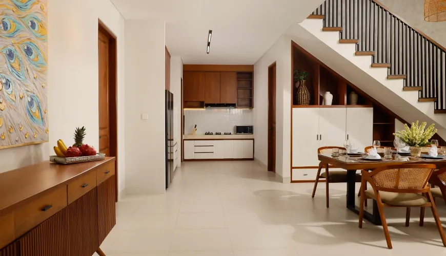 Clean, modern kitchen and dining area with minimalist wood design at Villa Ananya