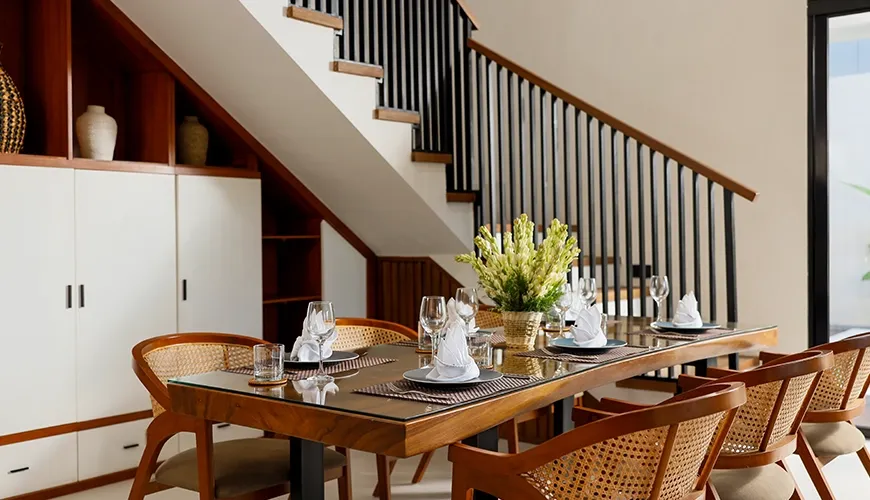 Elegant dining room with wooden table and woven back chairs at Villa Ananya