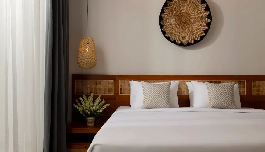 Modern bedroom with minimalist bali decor and woven art at Villa Ananya