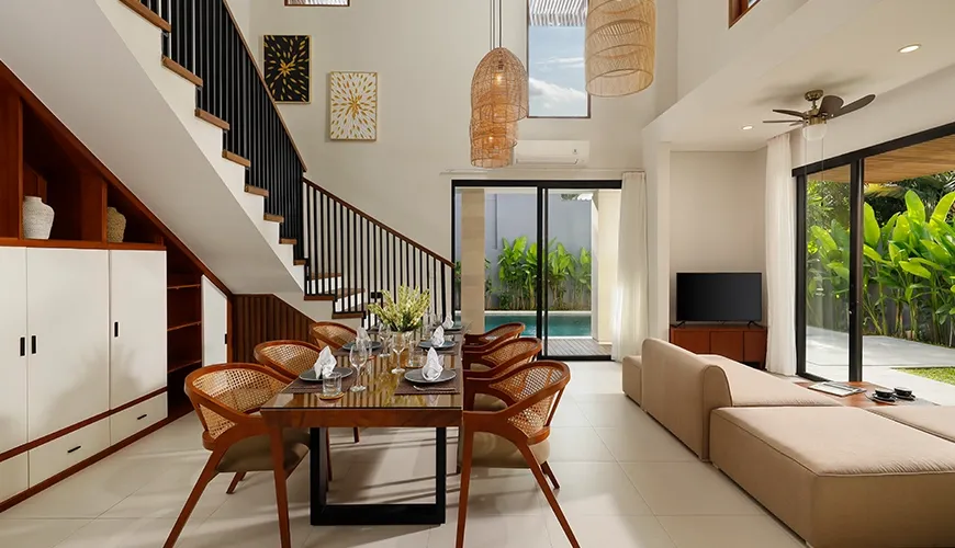 Modern open plan living dining area with comfortable sofa pool view at Villa Ananya
