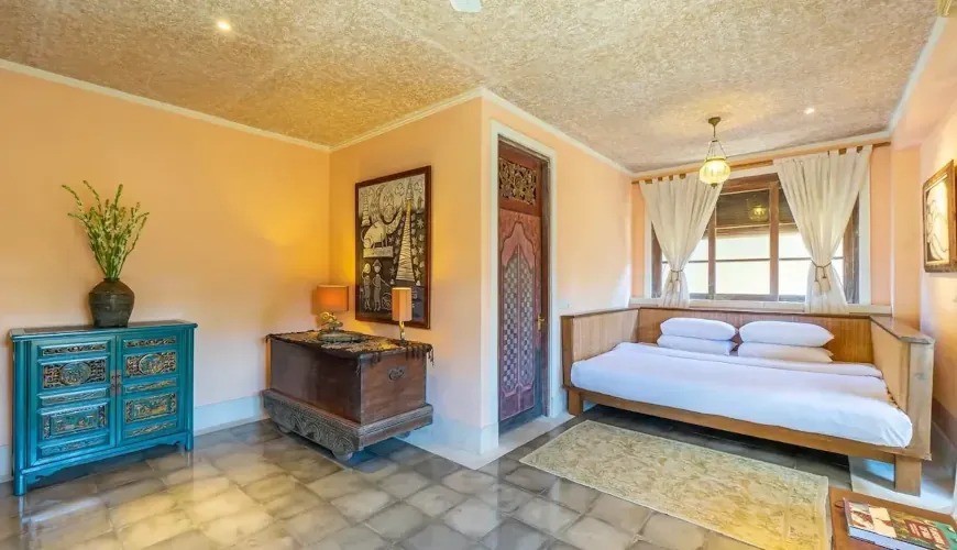 A spacious master suite featuring Zanzibar-inspired decor, a large bed, and cozy seating area at Villa Angsa