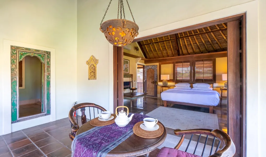 Balinese bedroom with daybed and breakfast table at Villa Angsa