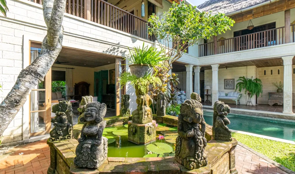 Courtyard with a Balinese stone fountain and statues at Villa Angsa