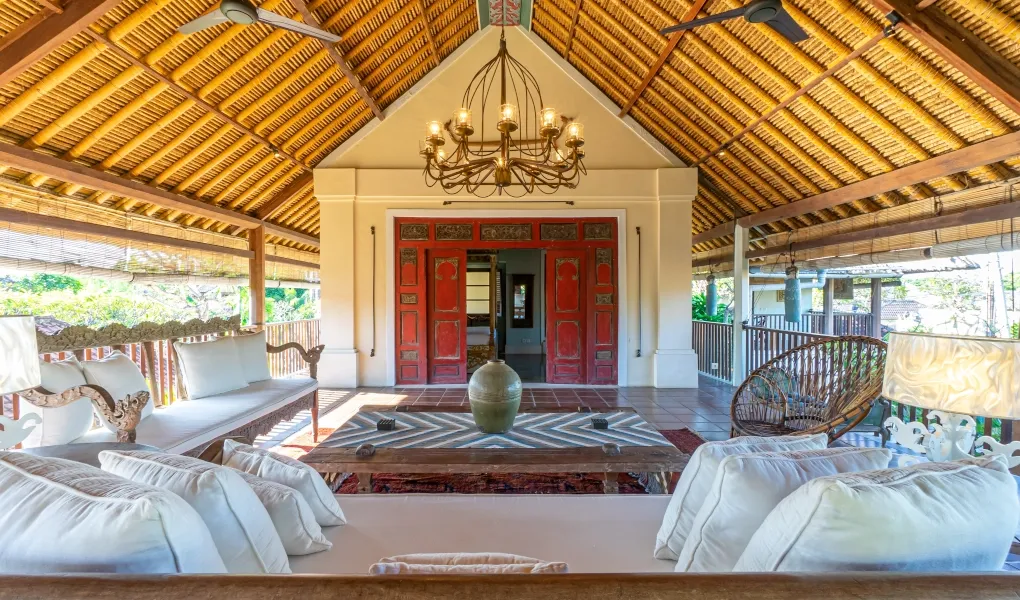 Luxury open-air terrace with comfortable seating and a Balinese thatched roof at Villa Angsa