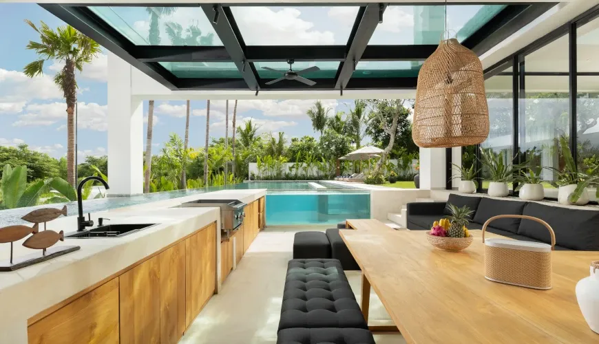 Indoor-outdoor bar and dining area with pool view at Villa Arita