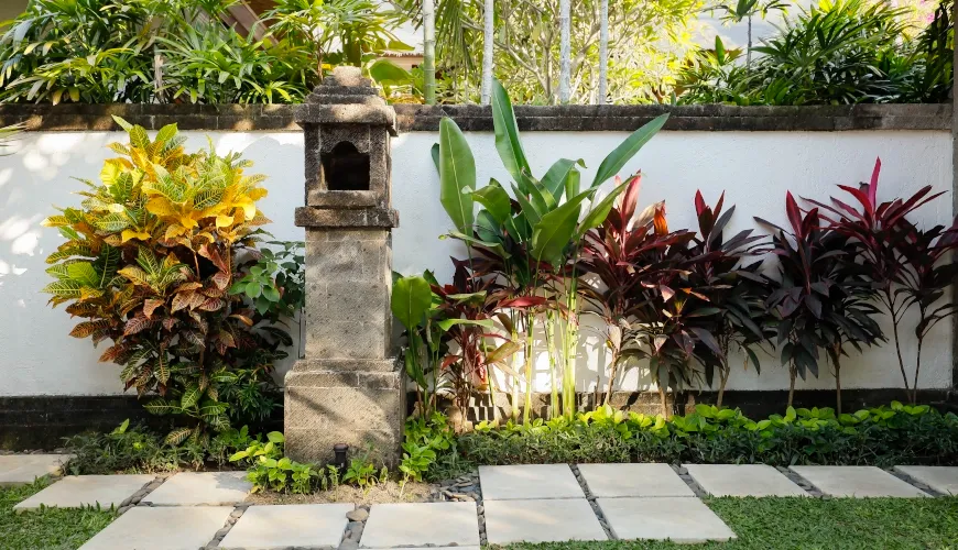 Beautiful traditional stone shrine in a lush Bali garden at Villa Avaya