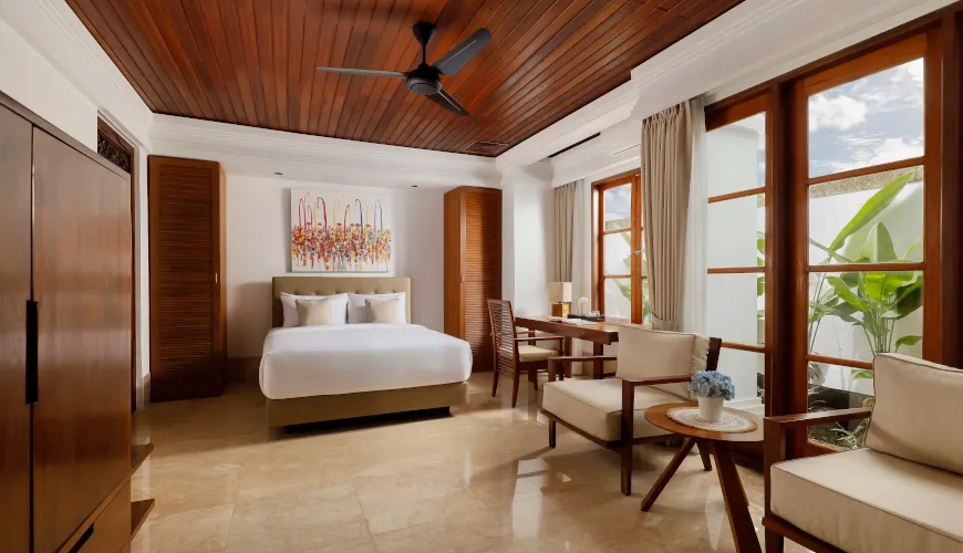 Bright Bali bedroom with wooden ceiling and modern furniture