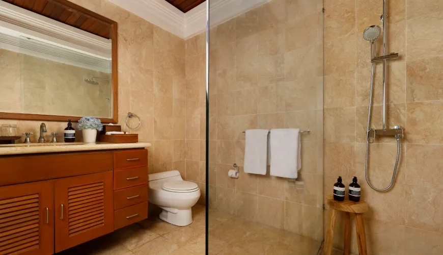 Classic marble bathroom with a wooden vanity and a glass walk-in shower