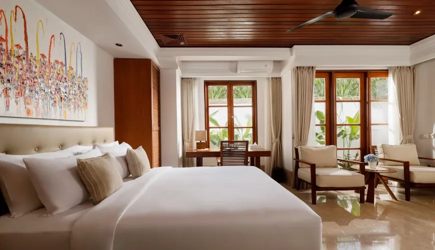 Comfortable Bali bedroom with modern art and light wood accents at Villa Avaya