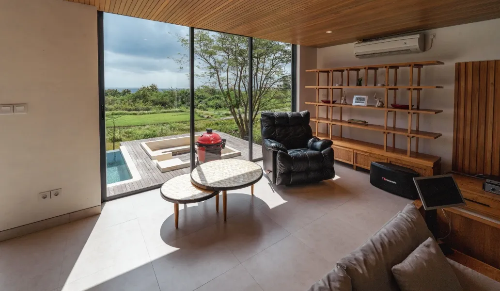 Bright living room with floor-to-ceiling windows and outdoor view at Villa Avocagolf