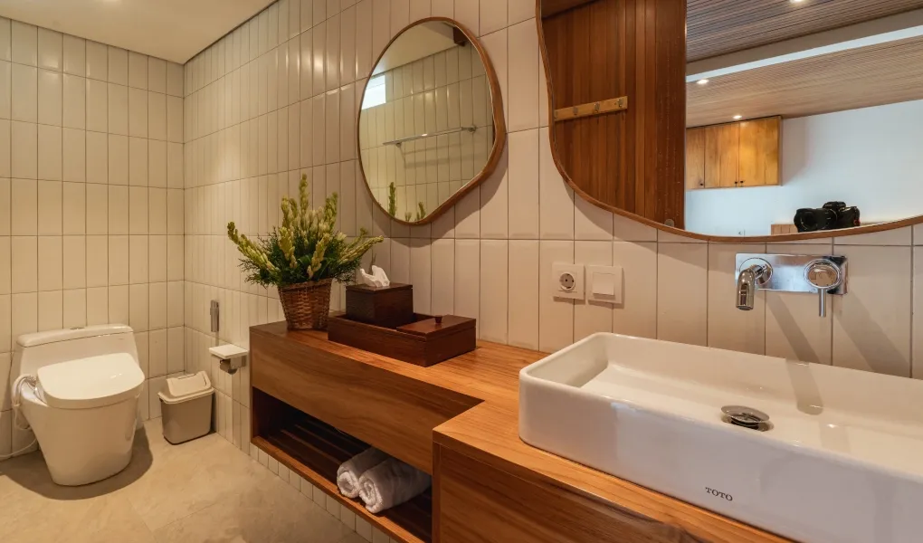 Contemporary bathroom with wooden vanity and unique mirrors at Villa Avocagolf