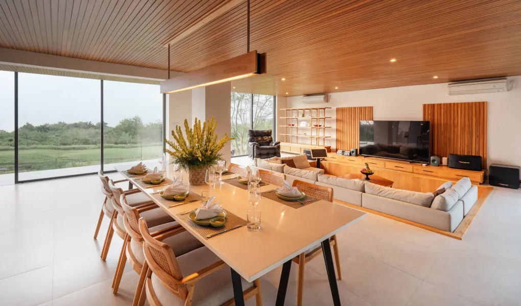 Luxurious open-plan living and dining area with panoramic windows at Villa Avocagolf