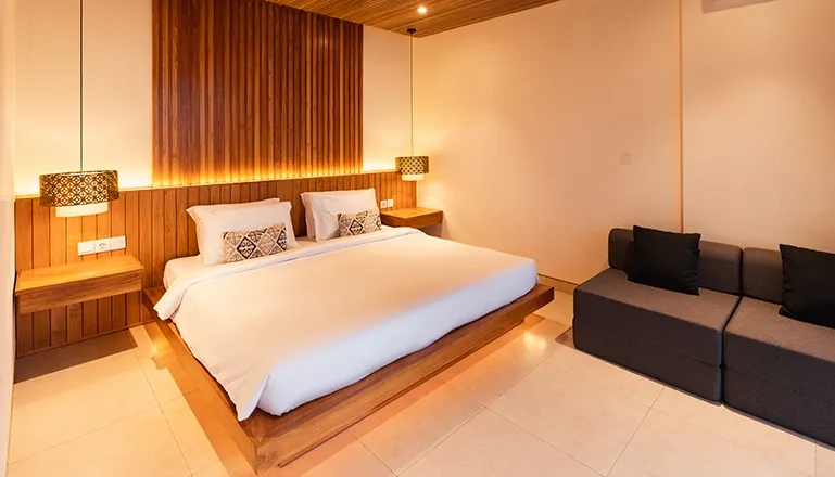 Luxury Bali villa bedroom with warm wooden accents at Villa Avocagolf
