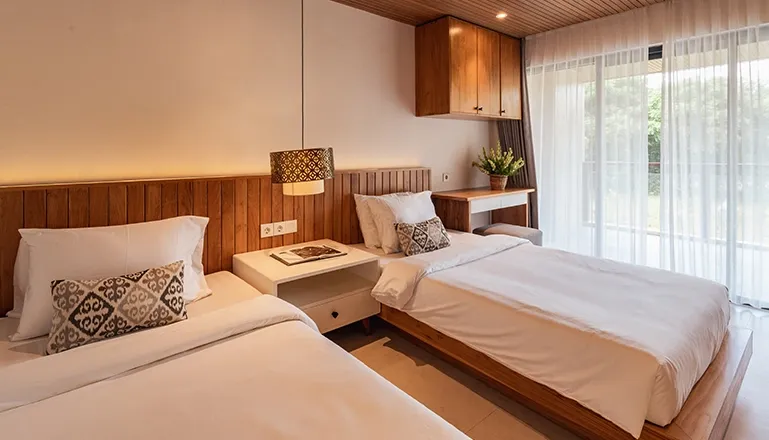 Sleek Bali twin bedroom, natural light, wooden accents at Villa Avocagolf
