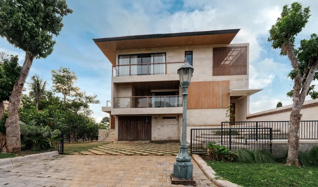 Striking modern villa entrance with a unique stone and wood design at Villa Avocagolf