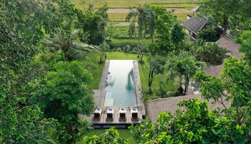 A luxury villa pool surrounded by lush greenery at Villa Bangkuang