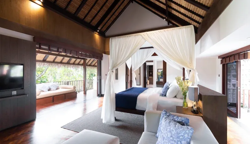 Bedroom with canopy bed, high ceilings, and terrace at VIlla Bangkuang