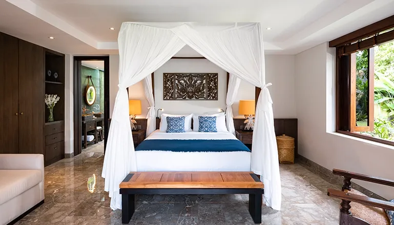 Luxurious second bedroom in a villa with a romantic four-poster bed and stylish blue and white decor at Villa Bangkuang
