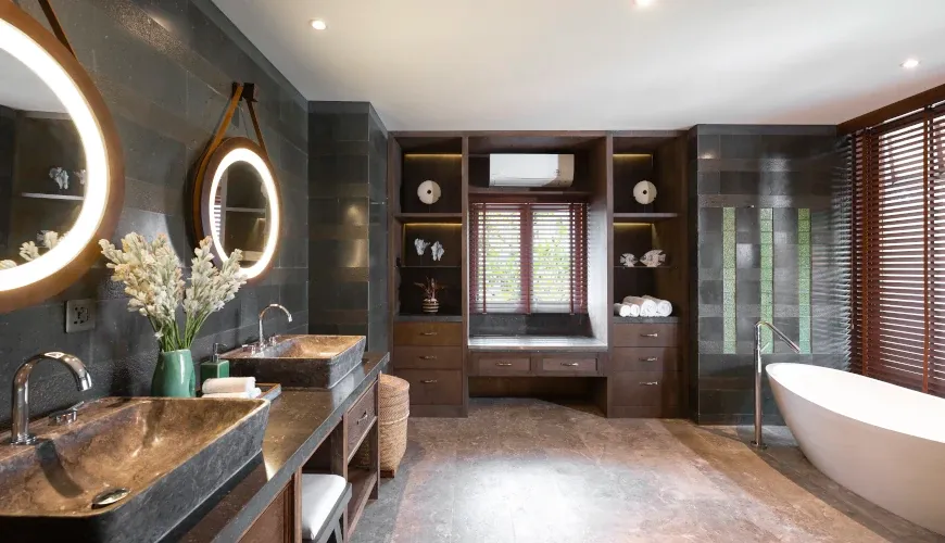 Stylish bathroom with double stone sinks and a standalone tub at Villa Bangkuang