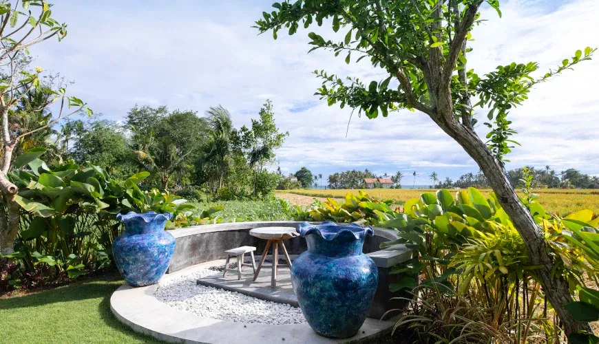 Tranquil outdoor seating area with rice field views at Villa Bangkuang